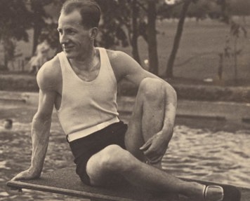 Karl Muffler posing in bathing costume on diving board. 