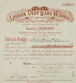 Water reservoir with poppet head, mine buildings and tall chimney in background.