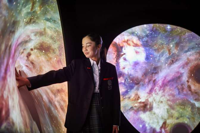 Schoolgirl interacting with science display