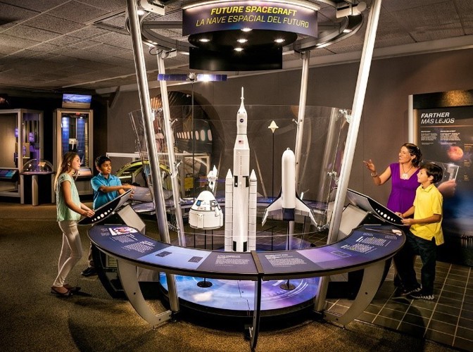 People looking at an exhibition interactive