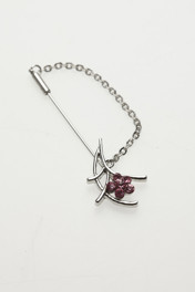 Silver brooch with pink crystals