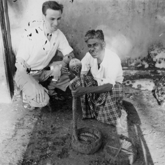 Snake charmer in Colombo, holding a cobra and 'Been' flute, circa 1957.