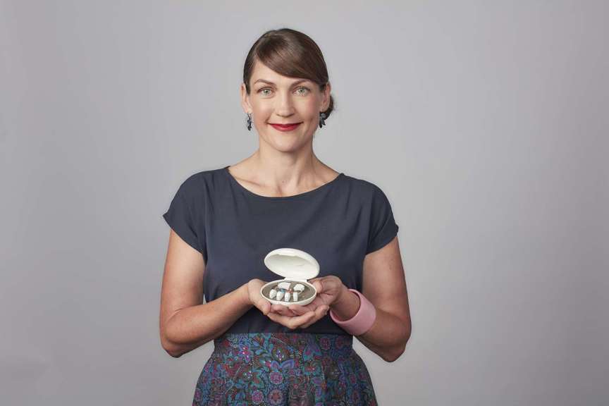 Woman holding hearing aids