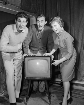 Woman & Two Men standing next to a Television Set, 1958