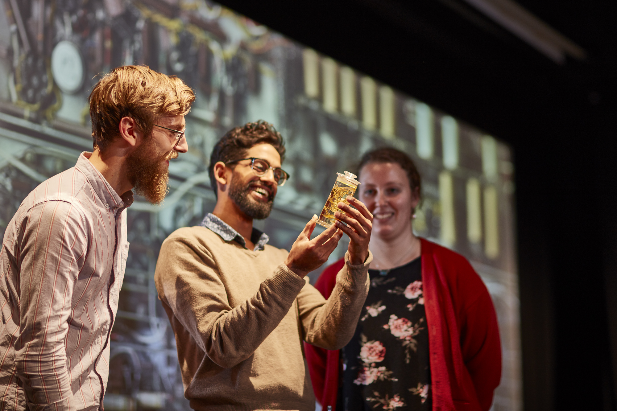 Promotional shot of museum staff presenting a lecture.