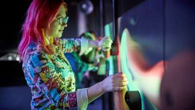 Woman interacting with museum installation