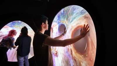 Visitors stretching flexible video screens