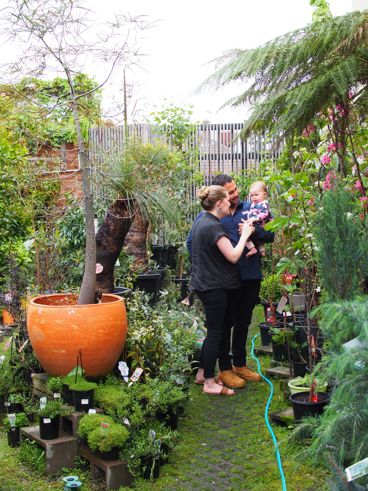 Michael Kahlil and Emily Welch, who is holding baby Agnes, in their plant nursery