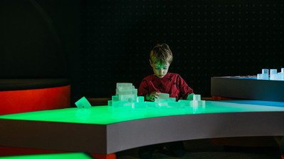 Child playing with Light Table blocks in the Ground Up exhibition