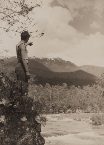 Man pointing to mountains in distance
