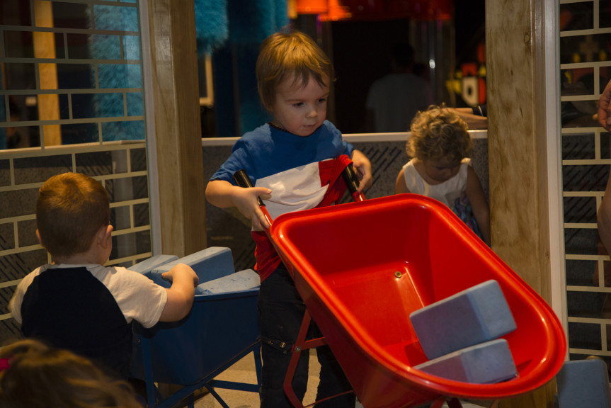 Children playing with the Blue Brick wall interactive in the "Ground Up" exhibition at Scienceworks