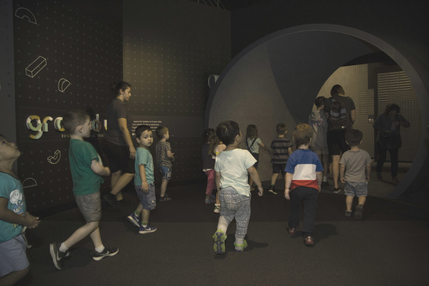 Children walking into Ground Up exhibition at Scinceworks. 