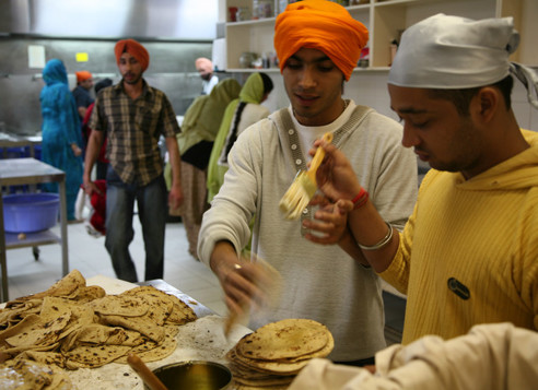Two men preparing flatbread