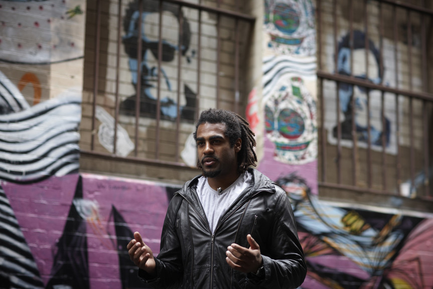 Man standing in the street with his hands out