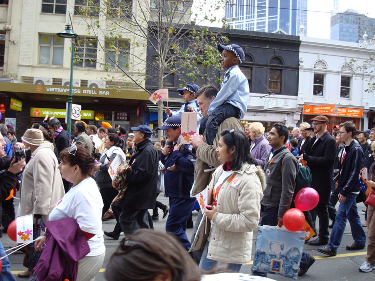 Large group of people working down the middle of the street