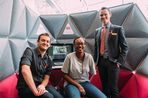 2 men and a woman in front of the Talking Difference Portable Studio