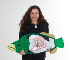 Artist Treahna Hamm holding her mixed media Murray cod