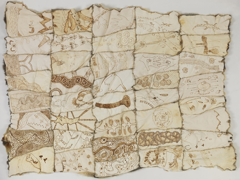 A series of possum pelts, skin side up, stitched together. 