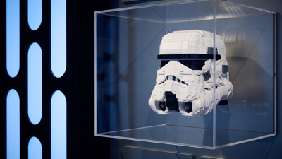 A stormtrooper helmet made of lego in a display case in LEGO® Star Wars: The Exhibition at Melbourne Museum.