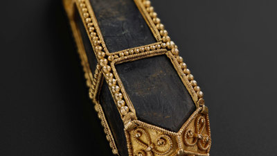 Black-stone pendant from the Galloway Hoard, showing the gold filigree work and distinctive pyramidal cap