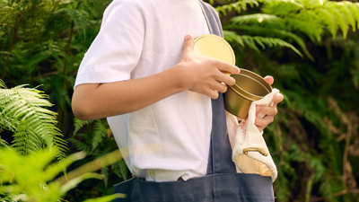 Children holding a tote bag filled with gifts in Gandel Gondwana Garden at Melbourne Museum.