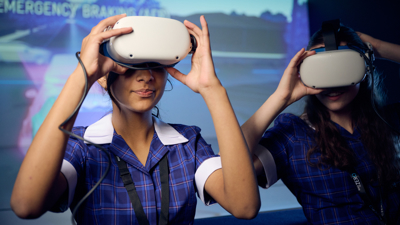 Two students in the Road to Zero Experience Space wearing virtual reality headsets 