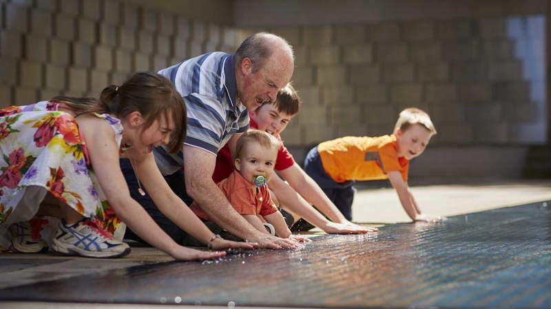  Visitor family in the Tribute Garden in Immigration Museum.