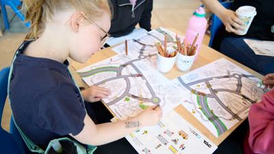 Children with craft materials and road maps at the activity, lower ground floor outside the Learning studios.