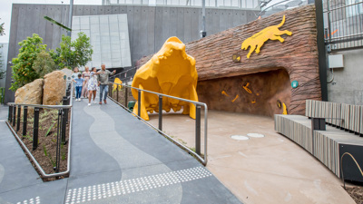Family walking down the ramp near the Thylacoleo skull in the Gandel Gondwana Garden