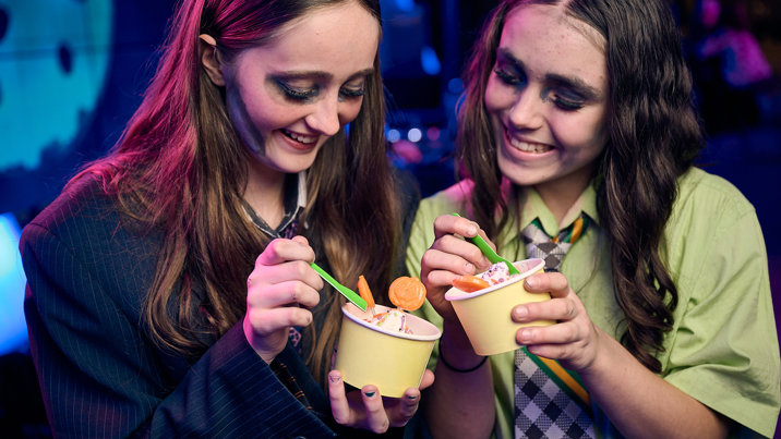 Two vampires enjoying sundae ice-creams together.