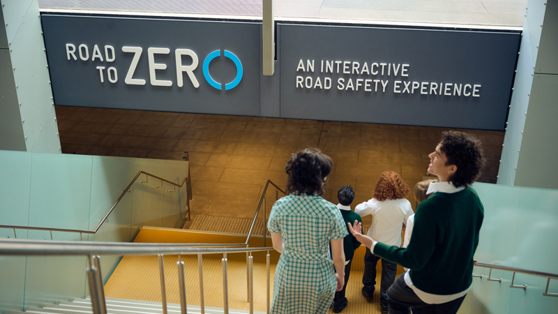 A group of students walking down the stairs at Melbourne Museum heading into the Road to Zero Experience Space 