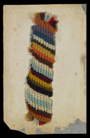 A page in Anne Trotter’s needlework book showing a multicoloured length of knitted wool.