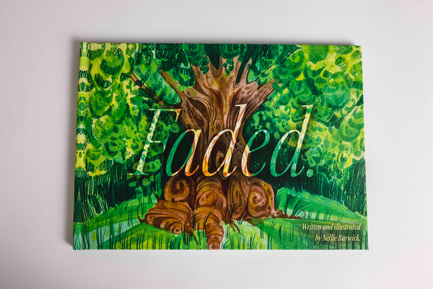 Hardback book whose cover features an illustrated tree with a thick, twisted trunk surrounded by green foliage.