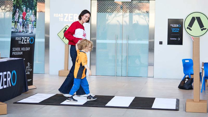 Adult and child using the zebra crossing at the activity, lower ground floor outside the Learning studios.
