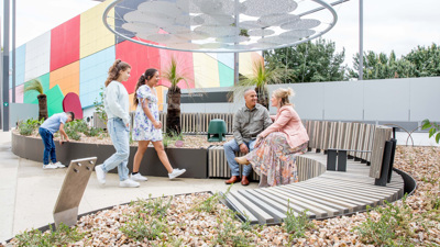 A family sitting in the Gandel Gondwana Garden
