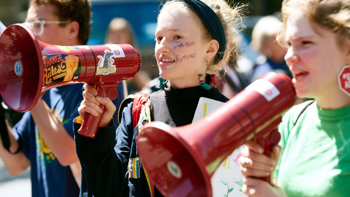 School Strike 4 Climate protest with two young people with loud speakers