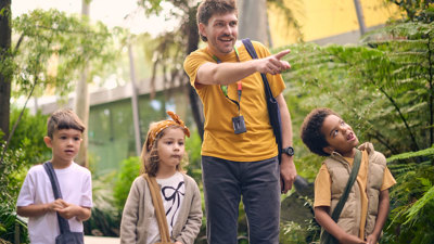 A tour guide points out something interesting in Gandel Gondwana Garden at Melbourne Museum.