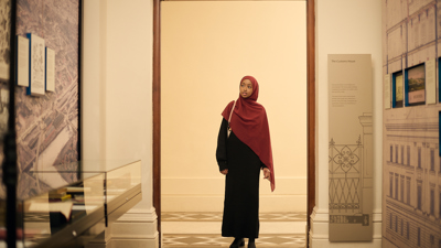 A young girl walks through the Customs Gallery at the Immigration Museum.
