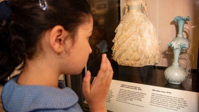  Primary school student looking at displays in Getting In exhibition in Immigration Museum.