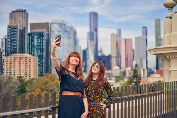 two women taking a selfie on the rooftop promenade.