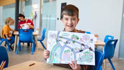 Children with craft materials and road maps at the activity, lower ground floor outside the Learning studios.